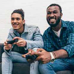 Two Guys Playing Video Games on Couch